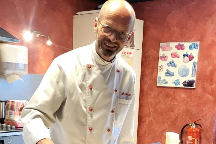 Pfarrer Markus Hoitz backt mit den Besuchenden Pizza